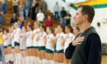Lions head volleyball coach Chris Willis stands with his team during the National Anthem this season. The Lions, 23-11 on the regular season await news about a bid to the NCAA South Central Regionals.
