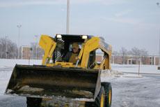 Contract worker Tyler Beck works Thursday to clear ice from the parking lot at the Anderson Justice Center.

