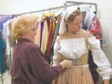 Linda Boles, costumer, and Lauren Alumbaugh, freshman undecided major, prepare for the Madrigal Feast by participating in the costume fitting in the basement of Phinney Recital Hall Feb. 15.
