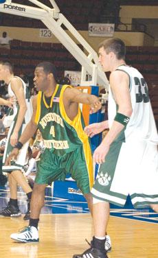 Junior guard Stanley Titsworth defends against Northwest in the MIAA Tournament March 1. The Lions fell 89-56.
