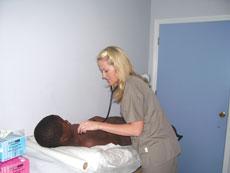 Amber Willis, senior nursing major gives a BVI citizen a physcial at a clinic
