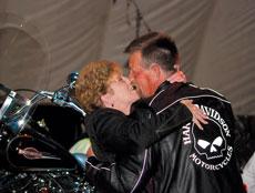 Randy Pease kisses his wife after he wins the Heritage Softail Harley Davidson at this years Black and Blue Ball.
