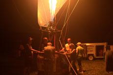 The crew of Dannys Mistress lights the balloon burner as part of the evening glow.
