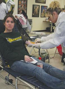 Janel Quesenberry, freshman nursing major, prepares to donate blood. Kimberly Williams swabs her arm during the Feb. 13 blood drive in Billingsly Student Center.
