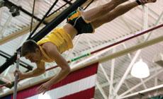 Sophomore Corey Shumate crosses the bar in the pole vault on March 1. Shumate finished fourth in conference competition.
