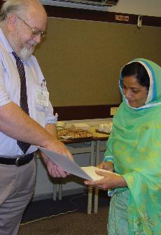 Dr. Willie Edwards presents a certificate to one of his Pakistani students during an earlier trip. Edwards will spend most of the fall semester teaching in Pakistan.
