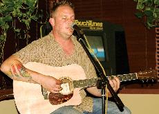 Adam Giebler, local musician and owner of The Tropicana, performs during the Thursday open mic night at The Tropicana. Giebler has open mic night every week and also brings in musicians from all over to play shows. Upcoming shows are advertised on the sign in front of The Tropicana.
