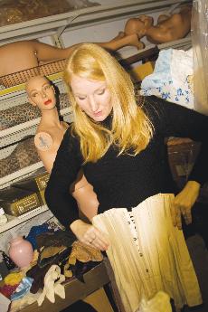 Senior English major Tara Clark examines a corset.
