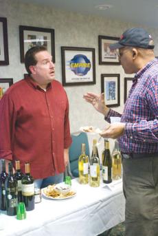 Michael Hagan of The Vinery Wine Shop and Jim West chat at the Klassix Society wine tasting.
