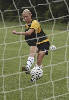 Sarah Evers, junior midfielder/forward, takes a shot on goal at a Lions practice Wednesday.
