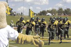 The Lions take the field Sept. 26 for their Homecoming match with Nebraska-Omaha as Lucy the Lion looks on.
