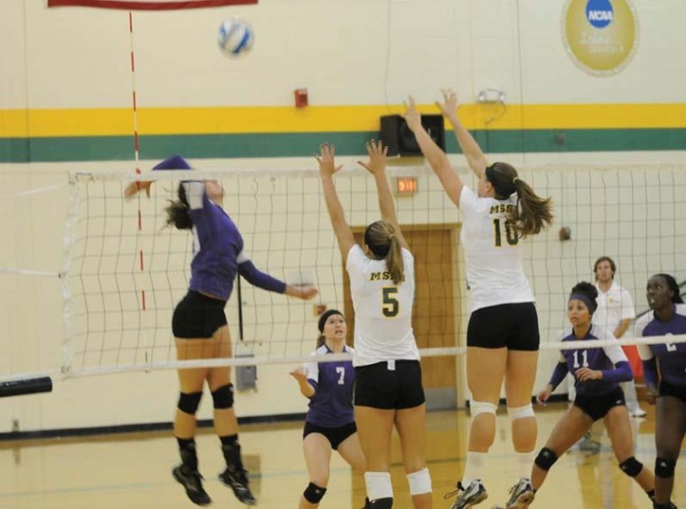 Casey Ball and Rachel Olinyk jump to defend a spike from a Southwest Baptist hitter on Sept. 17.
