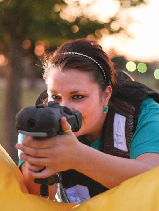 Junior Kaylee Washburn, Zeta Tau Alpha president, takes aim during Tuesdays laser tag on the oval for homecoming week.
