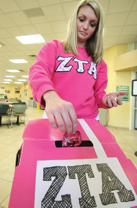 Mallory Roberson, senior health promotion and wellness major, and Zeta Tau Alpha member, places a yogurt top in a box to be shipped back to Yoplait. Ten cents for each top will be donated by the company to the Susan G. Komen Foundation for the Cure, an organization commited to breast cancer research.
