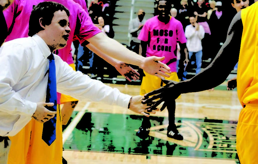 Rob, the down syndrome son of mens basketball head coach Robert Corn, gives five to the starters Saturday night before a home game against Missouri Western.
