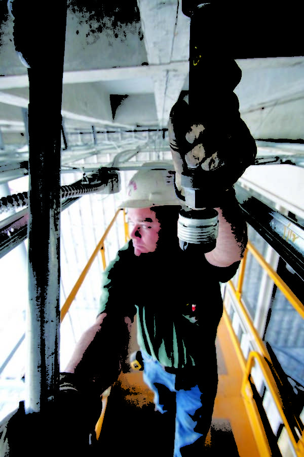 Brandon Lake of Main Line fire protection tightens a sprinkler pipe on the 3rd floor of Hearnes Hall Tuesday afternoon.
