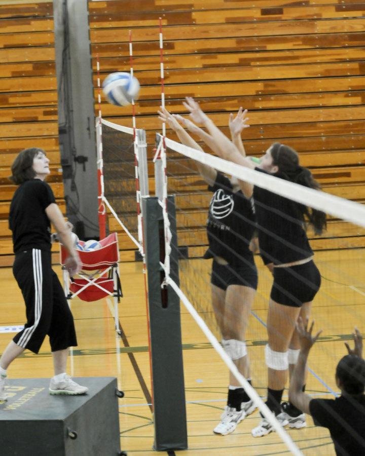 Trish Knight, Lion head volleyball coach, helps her blockers improve their game at practice Tuesday, August 28th.
