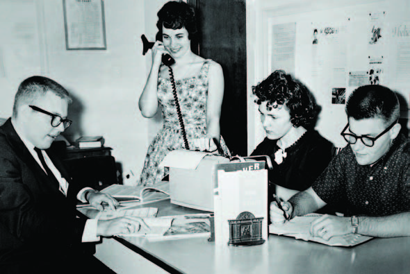 Members of a 1950s Chart staff work to produce the newspaper.
