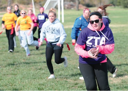 Freshman Kyleigh Shaw catches a pass and takes off toward the end zone, leaving other players in her dust during last weekend’s Alpha Sigma Alpha powder-puff football game. Money raised from the game went to Girls on the Run, the group’s national philanthropy.
