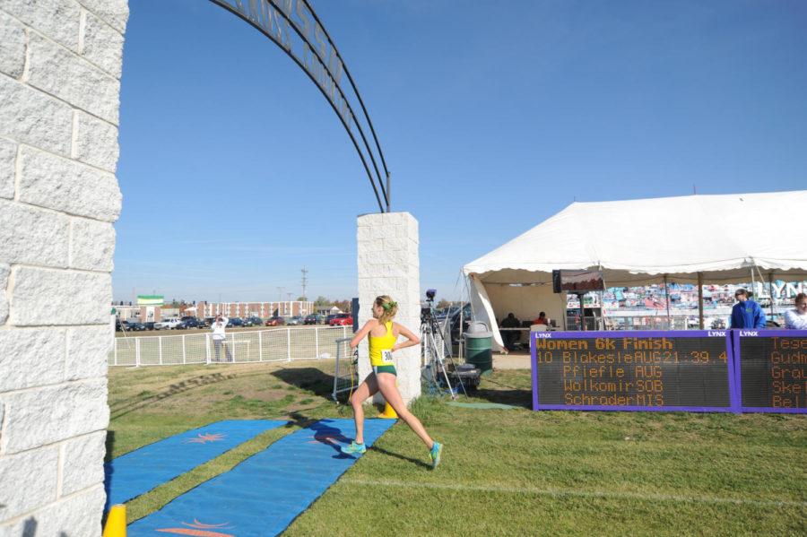 Junior Rachel Schrader crosses the finish line during last weekend’s race. Schrader finished the race 11th overall.
