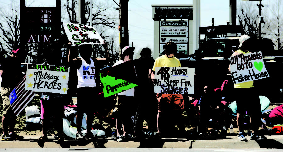 Members of Kappa Sigma hold signs and wave at traffic passing by the Kum & Go on Seventh Street and Duquesne Road from 3 p.m. Wednesday till 3 p.m. on Friday. The No Sleep for Soldiers event was held to raise money to aid returning veterans and their families.
