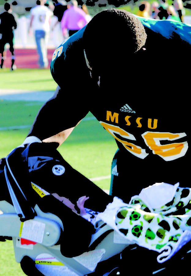 Brandon  Williams looks in on his son, Ryder, the game against Northwest Missouri State University on Oct. 24, 2012. Williams had one sack in the game, taking sole possession of the all-time Missouri Southern sack record, passing Lion legend Ken Shorten.
