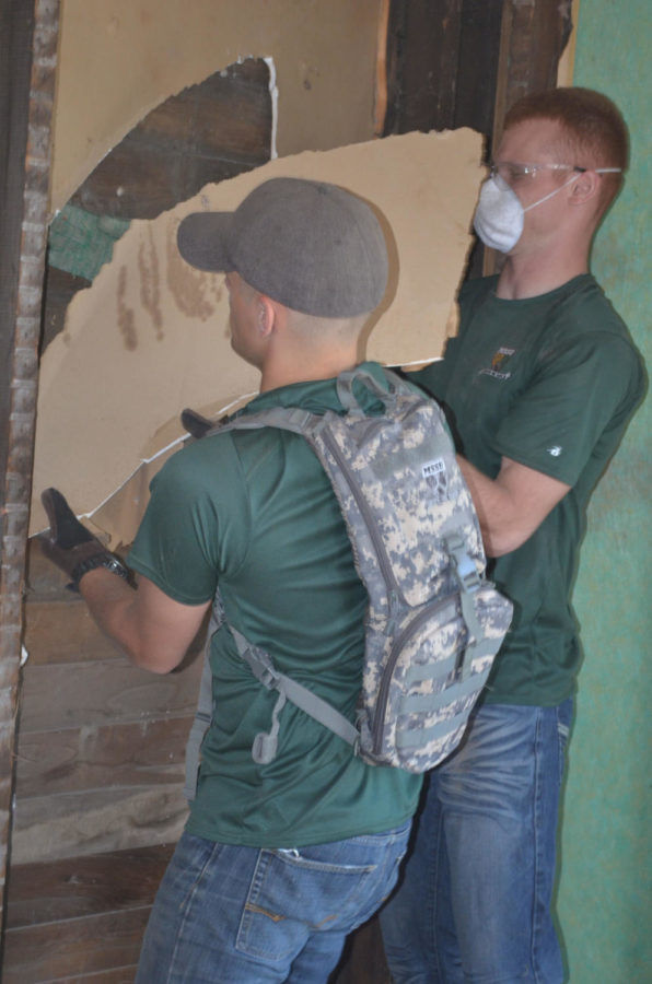 Candidate Bain and Candidate Wooldridge, members of MSSUs Show-Me Gold officer candidate training program, tear out pieces of sheet rock. Show-Me Gold teamed up with Home Sweet Homes USA Inc., Sept. 21, as part of thier community involvement.