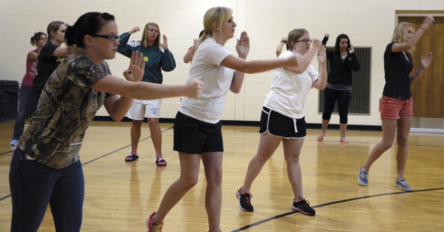 Women attending the rape aggression defense class on Sept. 12 practice the hammer fist.