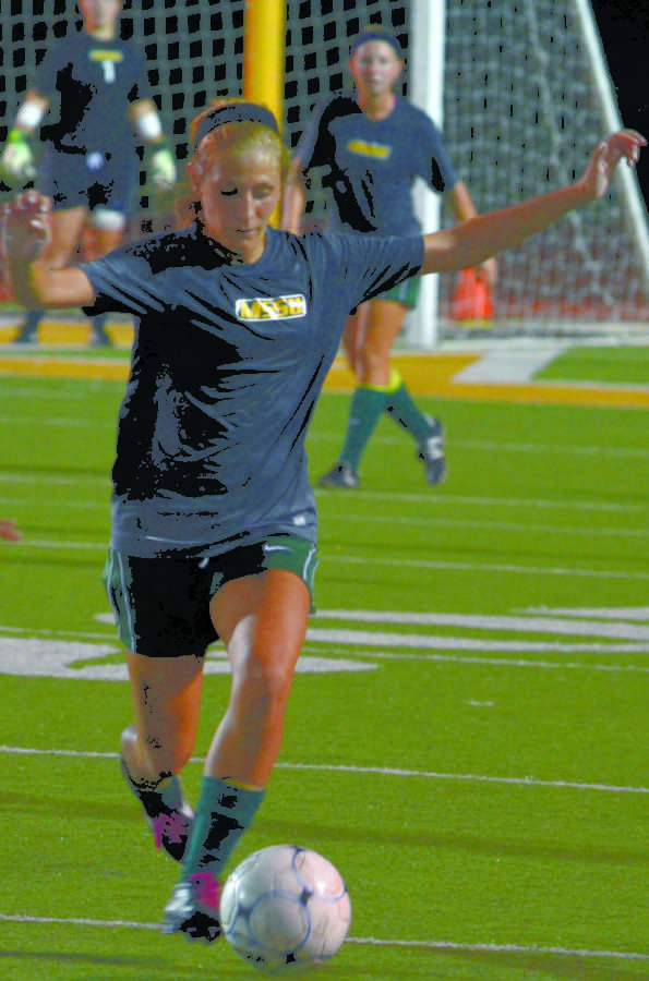 Senior Dana Wilhelm takes the ball down the field during a scrimmage earlier in the season against John Brown University.
