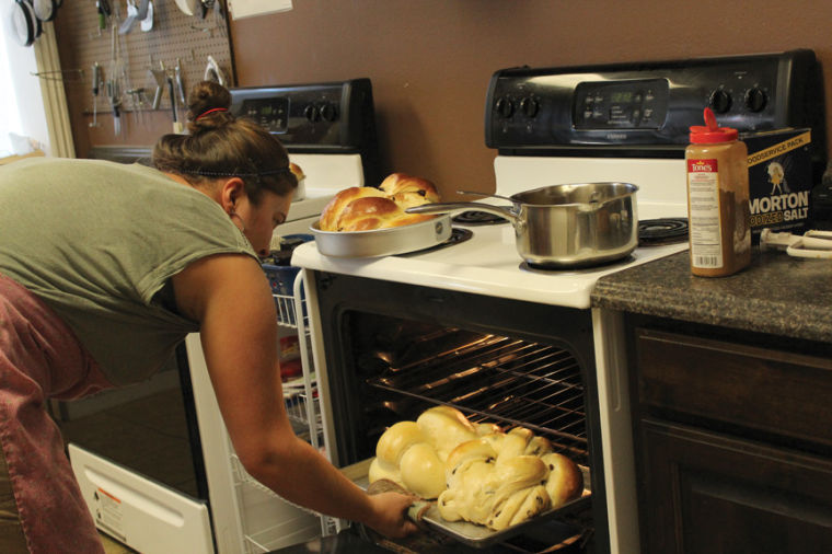 Turning Challah bread in the oven, Bethany Lewis, owner of Edens Bakery, bakes the sweet rich egg bread for Rosh Hashanah. The traditional bread was baked for the Jewish New Year. The round loaves symbolize the cycle of the year and are sweet to honor a sweet new year.