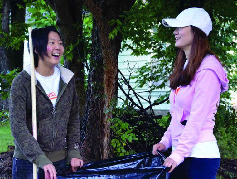 Tomomi Uchino, left, IEP exchange student from Japan and Jiayi Xu, right, sophomore psychology major from China, chat while work at Great Day of Service.