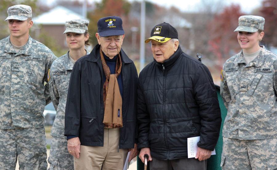 Leland Browne, left, served as a Seabee from 1951 to 1955 and John Cragin served in the United States Army from 1943 till 1967. Both stand with members fo the Show-me Gold program at the end of the MSSU Veterans Week Memorial Ceremony on Nov. 11.
