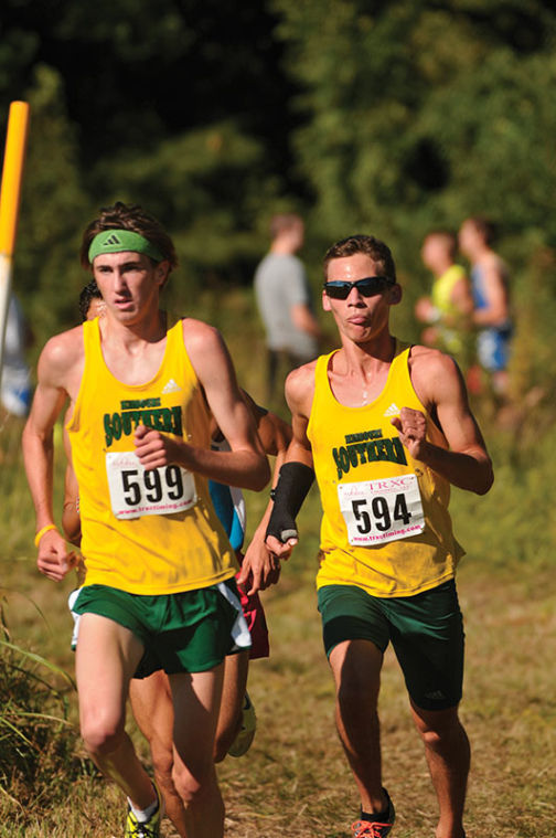 Junior Eric Schott and senior Jake Benton run together at the Southern Stampede where the Lions finished in first place.