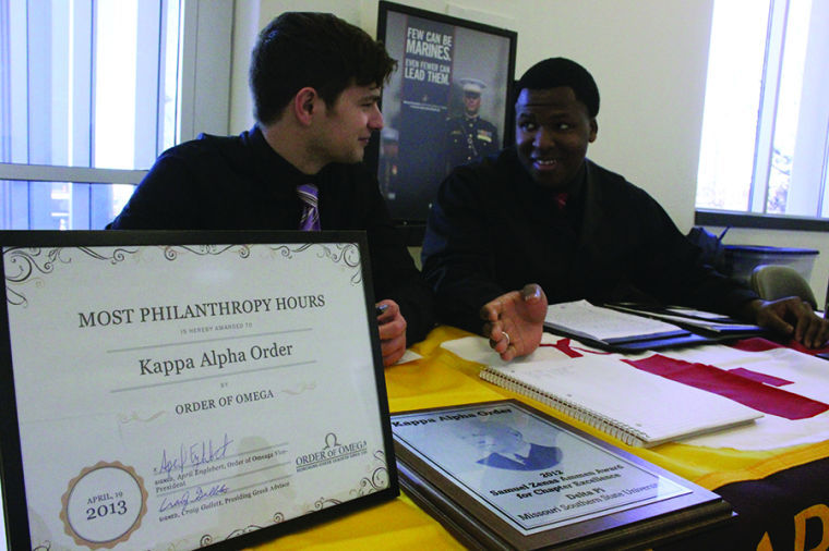 Freshman CIS major, Ben Lovejoy (left), and senior criminal justice major, Evan Moore, display the awards and recognitions while interacting with students at the Volunteer Fair on Jan. 22 in Billingsly Student Center.