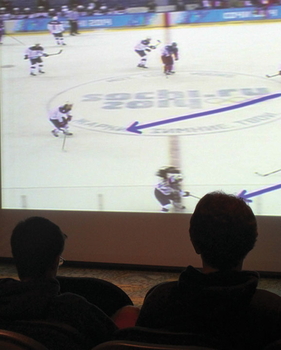Dustin Foster, a sophmore education major, left, and Dalton Lester, a sophmore health and wellness promotions major, root for the US Olympic hockey team, during a live showing in the Phleps Theater on Wednesday, Feb. 19, 2014.