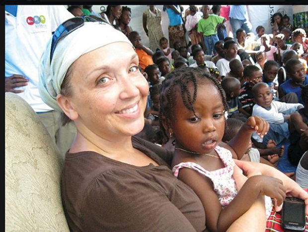 Roxanne Clement, the late sister of Joplin High School Assistant Principal Sandra Cantwell, spends time with children at an orphanage in Haiti.