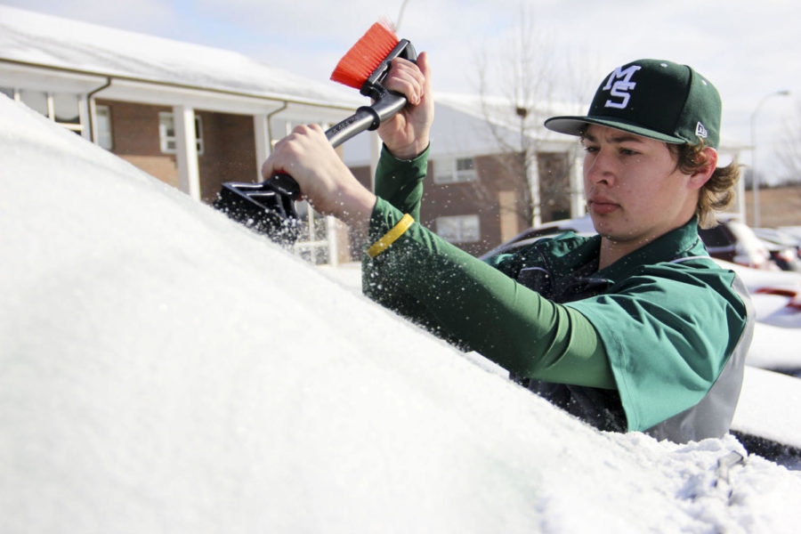 Freshman Southern baseball player Carlos Guaderrama scrapes the hard ice off his truck so he can make it to practice at PlayMakers.