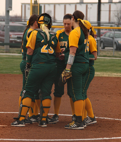 Infielders meet on the mound to start the inning