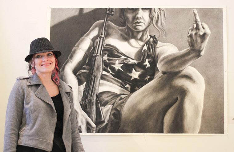 Sandra Conrad, a senior studio art major, stands with her first place winning entry in the 37 Prime competition at Spiva Art Gallery on Tuesday, April 15.
