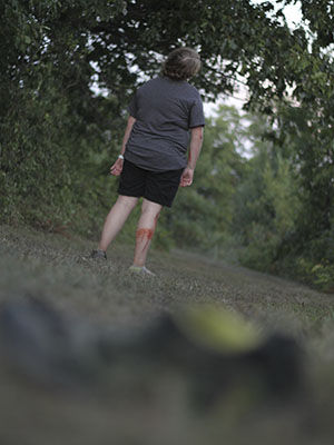 Shelby Thornton, a sophmore political science education major, wanders away from her lost shoe as she keeps in zombie character on Friday, August 22 at the cross country track.