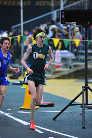 Junior distance runner Eric Schott led his race around the track inside the Leggett & Platt Athletic Center on March 2, 2014 during the MIAA Indoor Championships where the Lions finished second.
