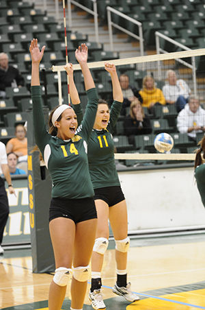 Junior middle hitter Payton Graves (front) and senior Katie Politte celebrate after a point during the Spike or Treat contest against Northwest Missouri on Oct. 27, 2012. The Lions fell 3-1 in the contest during a tough year that ended with a 0-30 record.