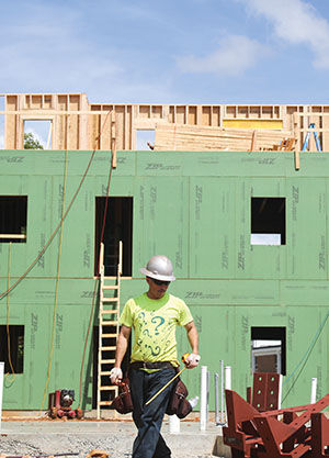 Misael Hernandes, a worker for R.E. Smith, takes measurements at the dorm construction site on Wednesday, Sept. 3.