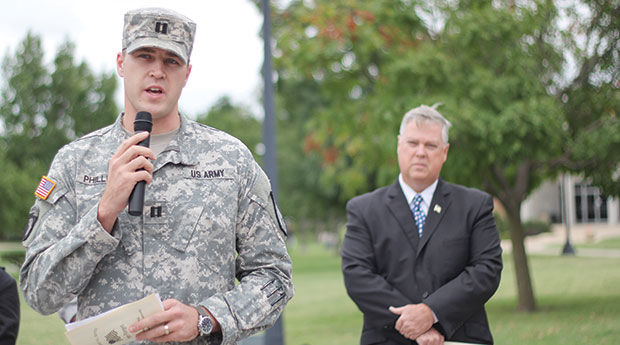Missouri National Guard Captain Chase Phillips (left) gives a short speech before the moment of silence at yesterday’s 911 memorial on the Oval, while Darren Fullerton, (right) vice president of student affairs, watches. This marks 13 years since terrorists attacked the United States.