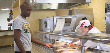 Darius Taylor, a freshman information technologies major, receives his lunch on Thursday, Oct. 9 at Mayes Dining Hall.