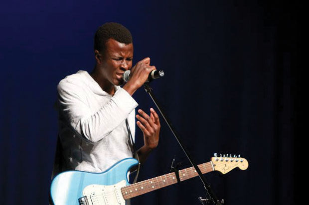Ngosa Simbya sings and plays guitar at the MOSO Talent show on March 11, 2014, at Taylor Performing Arts Center.