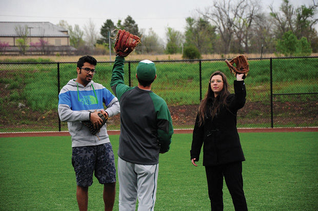 International+students+Aditya+Malhotra+%28left%29+and+Maria+Julia+Lucas+Uchoa+%28right%29+learn+the+best+way+to+catch+fly+balls+in+the+outfield+on+Monday%2C+April+13.
