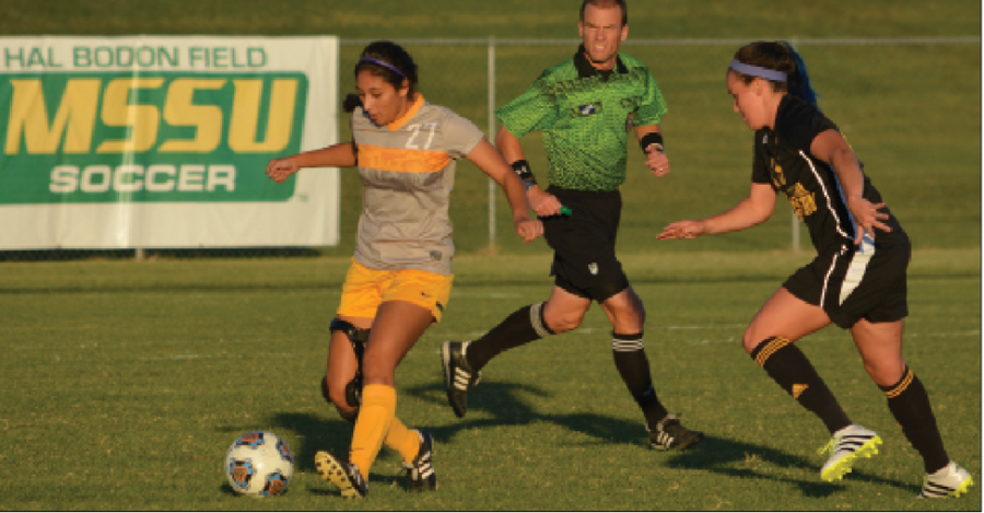 Freshman Brianna Valenica dribbling the ball against a Missouri Western defender on Hal Bodon Field against Mo. West on Sept. 29, 2016. Valencia has played in nine games this season for the Lions attempting two shots.