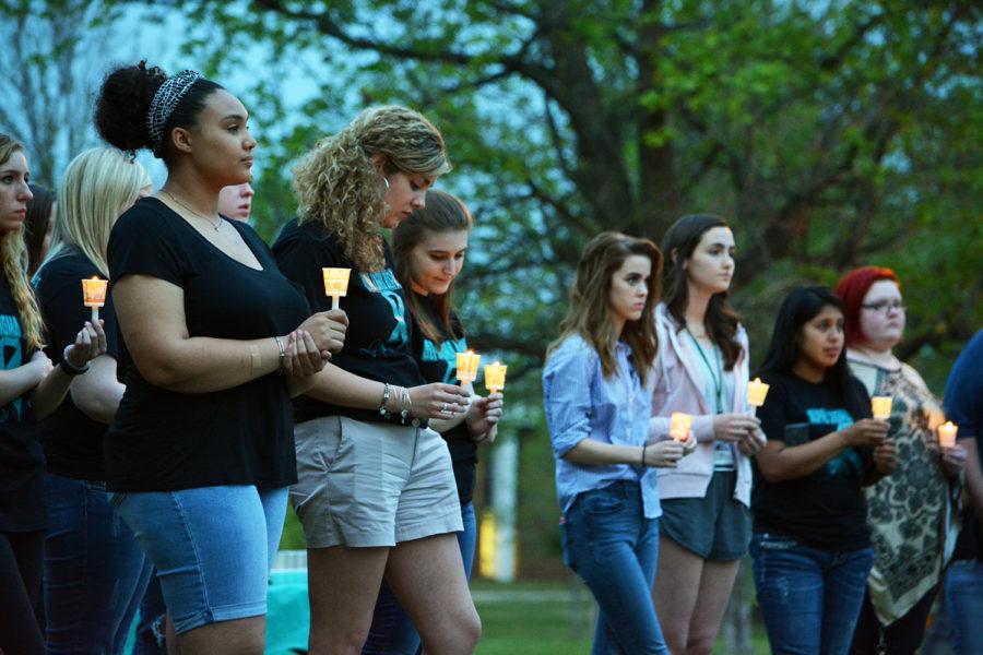 Daya Davenport, junior public relations major, participated in a candle light vigil at the Take Back the Night event hosted by the Alpha Sigma sorority and held on the Oval on April 13, 2017 to help raise awareness about sexual assault.
