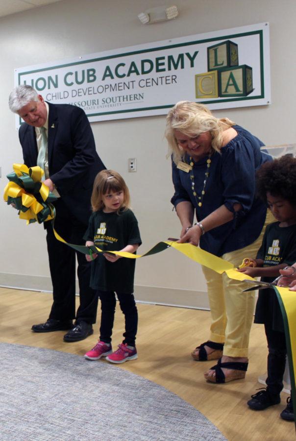 University President Dr. Alan Marble cutting the ribbon at the Lion Cub Academy opening.